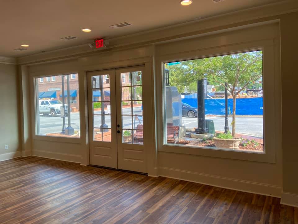 Photo from the inside of the storefront toward the street showing the store entrance and new windows.