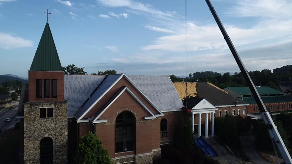 photo of crane assisting with unloading old asphalt tiles