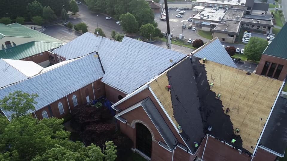 aerial photo of team working on roof removal