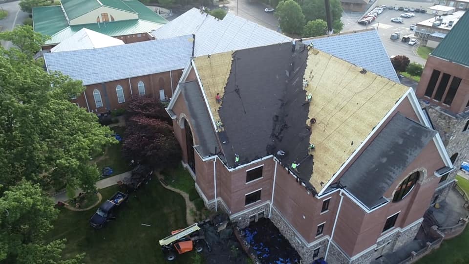 aerial photo of Ridgeline team removing large section of old roof materials.