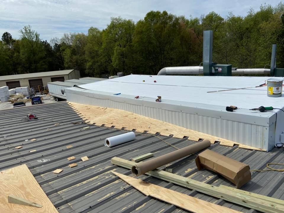 photo of bridge construction between the new equipment and the pitch of the metal roof