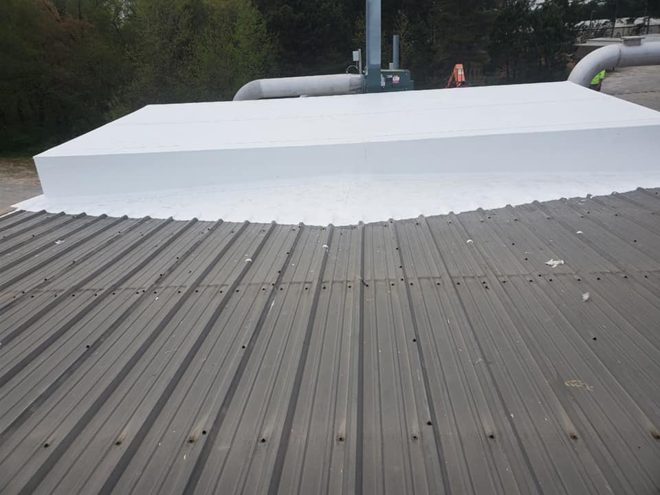 photo of side view of the wrapped equipment on the metal roof