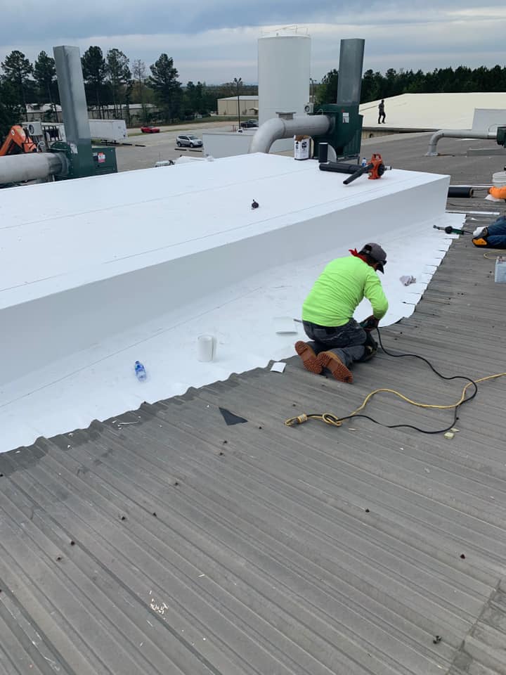 photo of Ridgeline Roofing team installing the seals and wrap for the roof cover