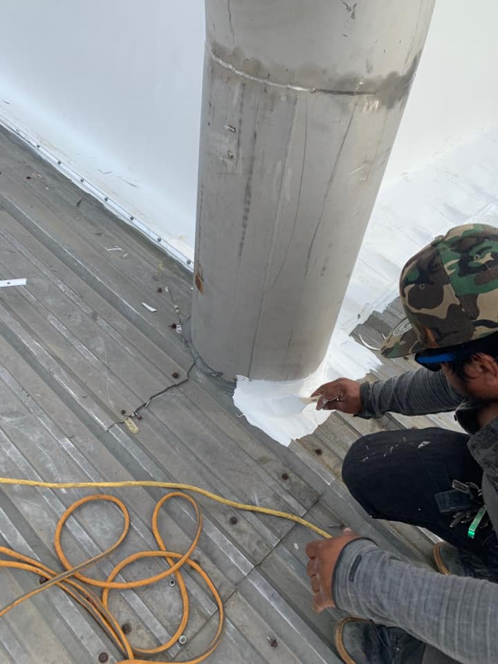 photo of close up of the sealing process around the vent pipe