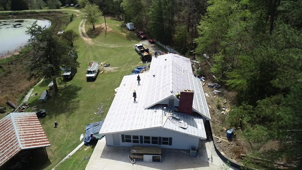 aerial view of the Ridgeline Roofing team installing the underlay roofing system for the metal roof.