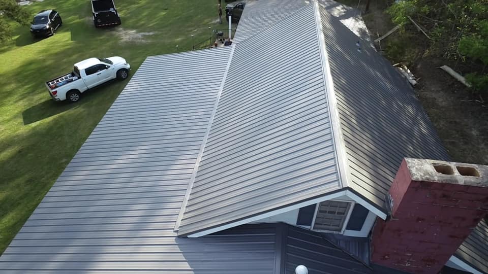 closer aerial view of the gray metal roof installation