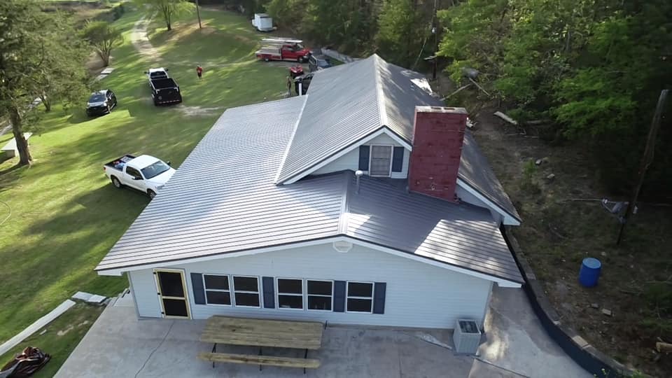 aerial photo of metal roof showing upper dormer, chimney flashing and roof pitch