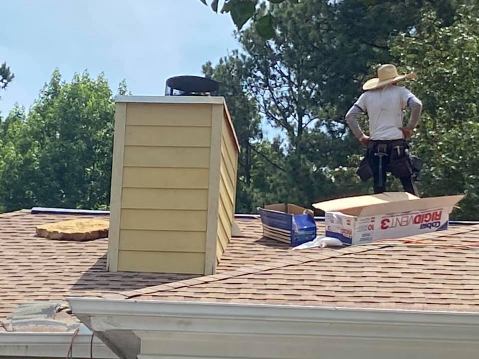 new roof materials being installed around a chimney stack