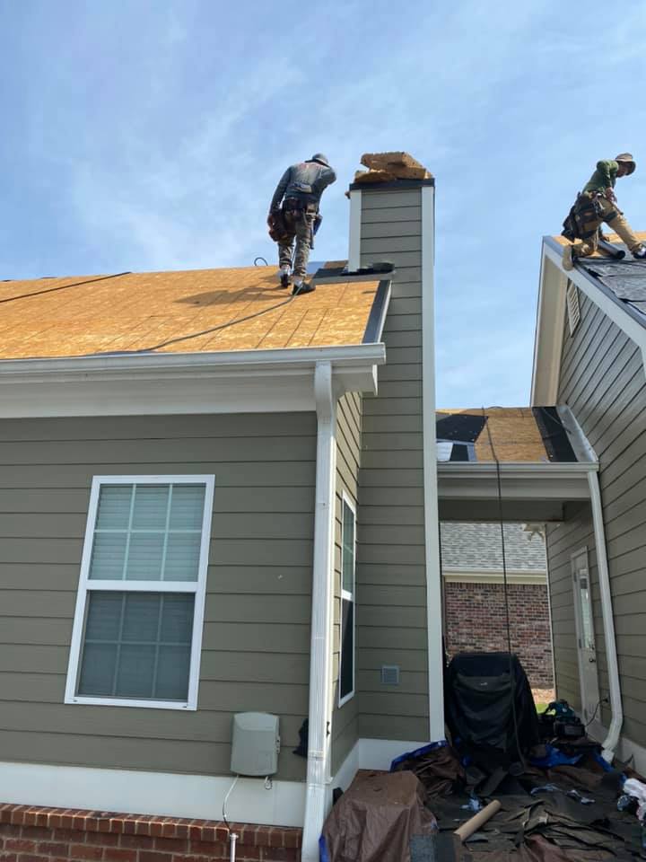 Photo of Ridgeline crew getting the decking ready for a new roof on the Bogart House