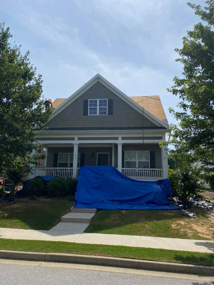 Photo of Bogart house with shrubs and front porch protected