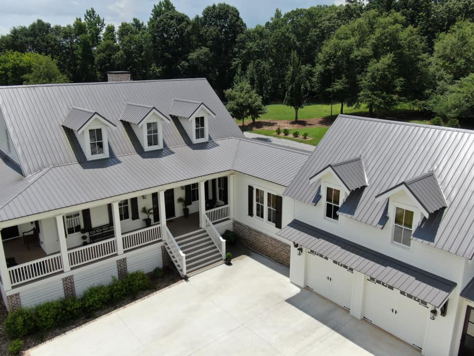 aerial photo of the entrance to the home and the breezeway with dormers of the garage