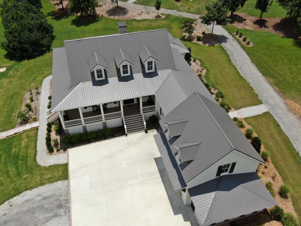 aerial view showing close up of garage and main living structure with covered connecting breezeway