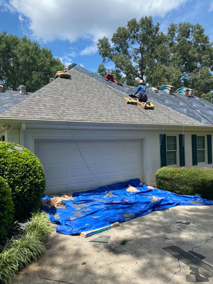 new roof installed on garage area with underlay being completed on the home