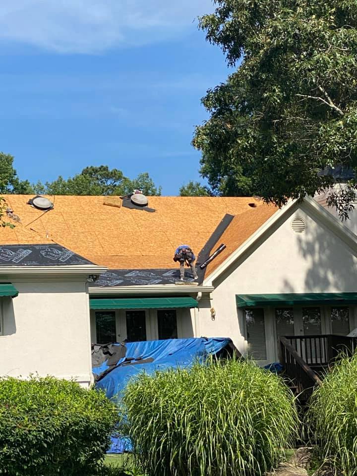 Old damaged tiles are removed and the decking and gutters are being prepped for the new roof