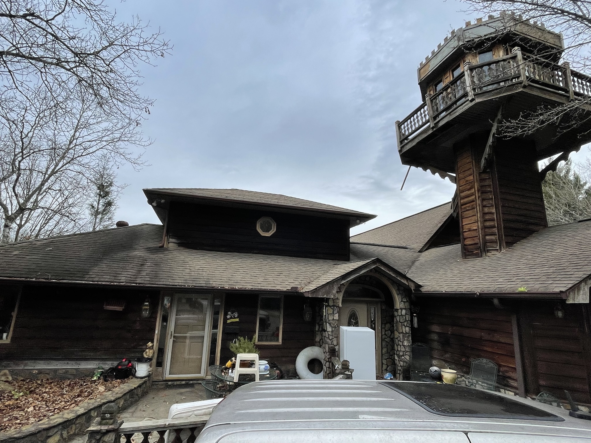 Photo of home prior to renovations which includes the ski lift turret tower