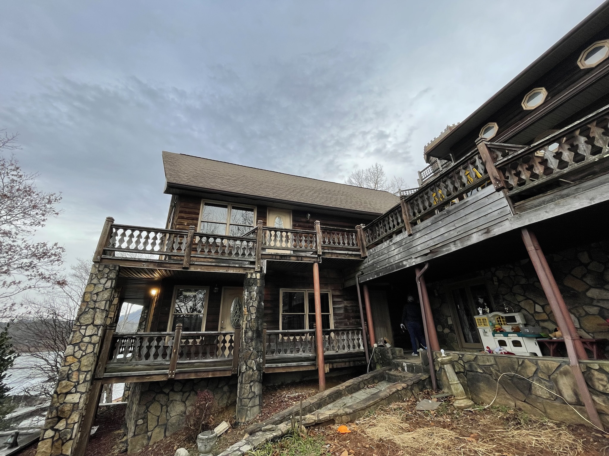 Photo of original home showing aging decks at rear of home