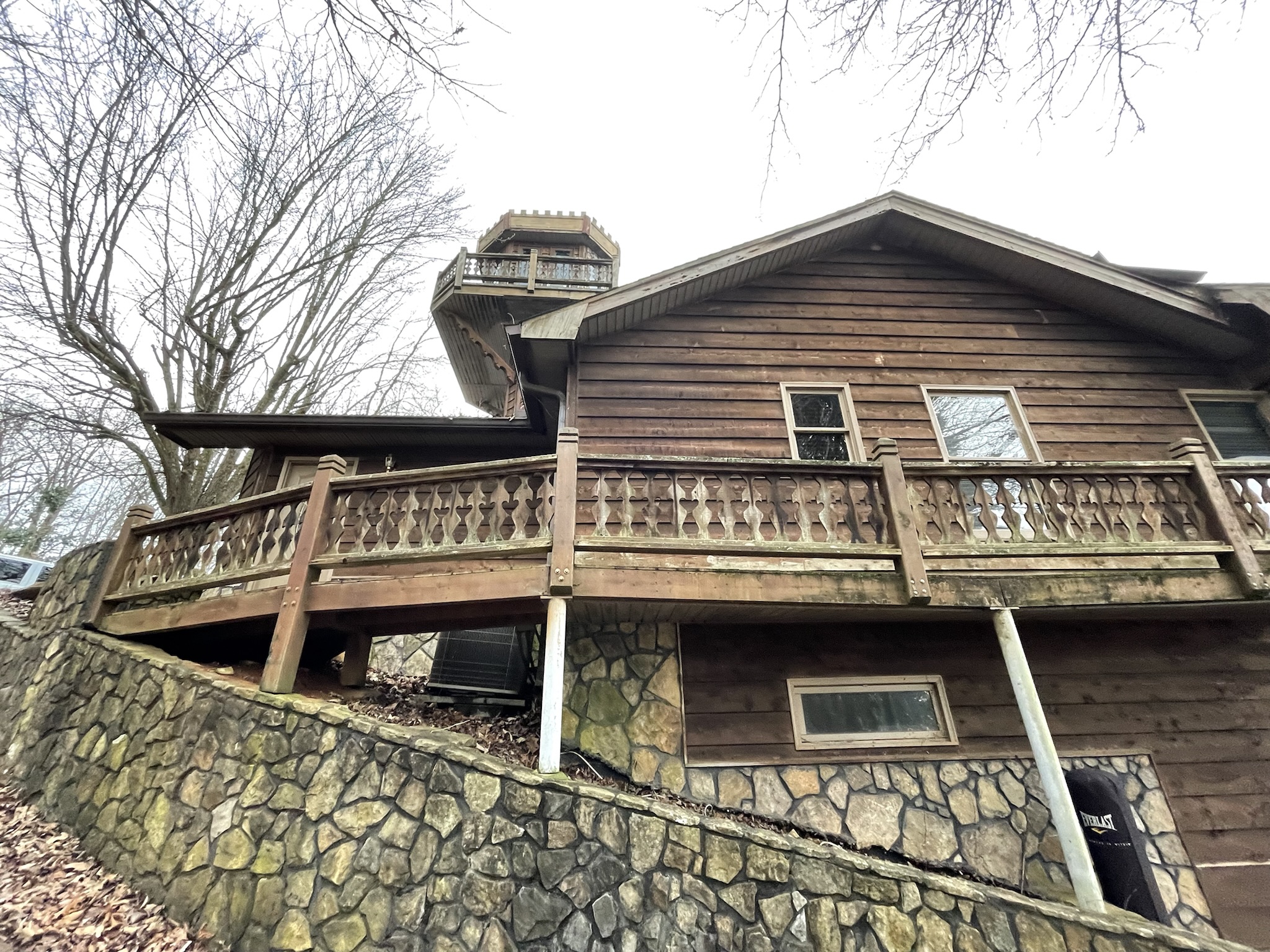 Photo of original home showing support structure on slope grade for upper deck