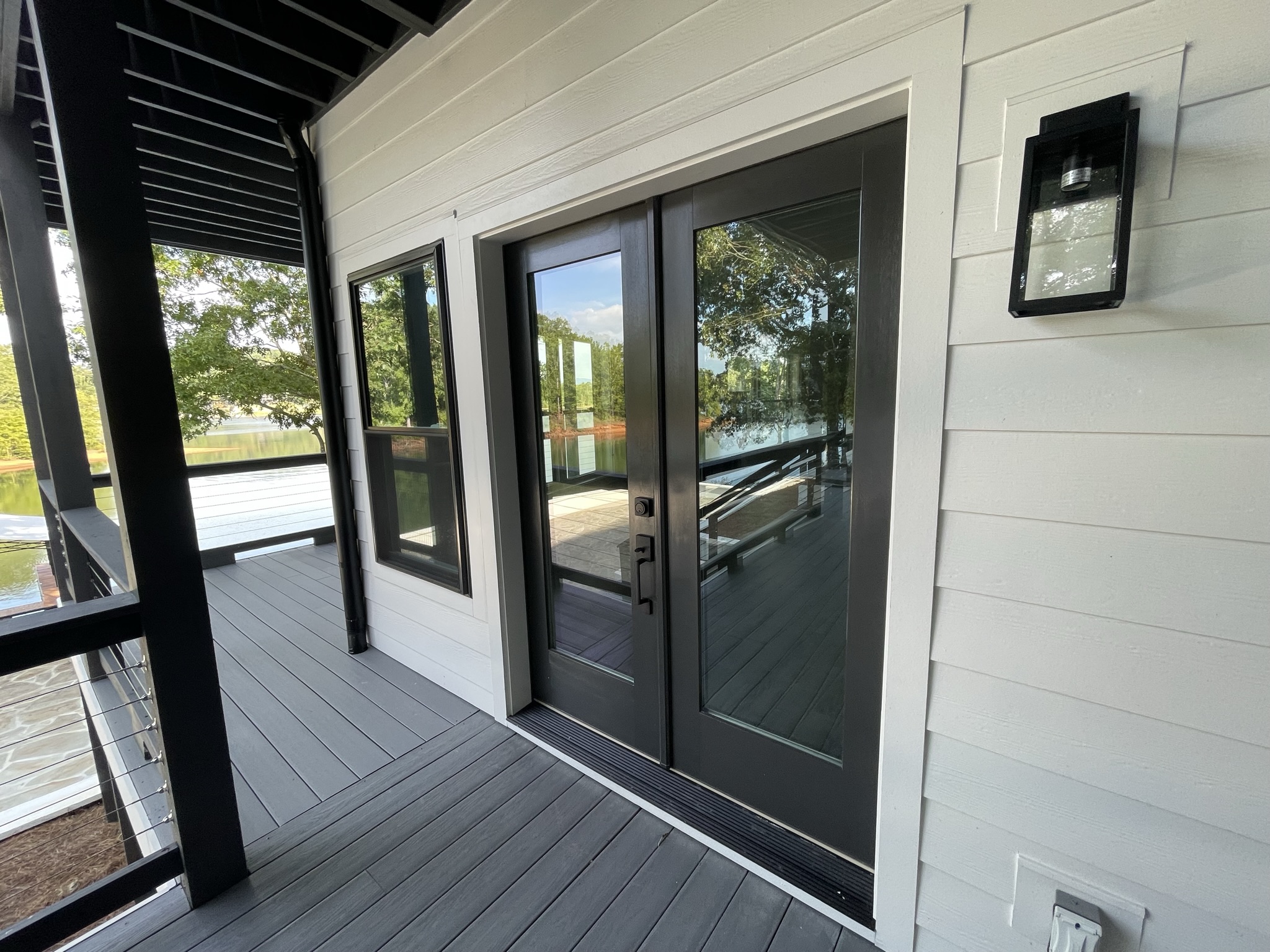 Photo of finished exterior double door and trax system decking