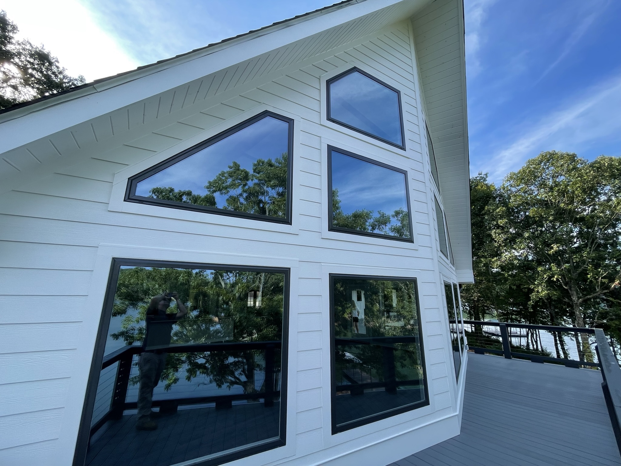 Photo of window system in great room with geometric fitted windows on a-frame just out