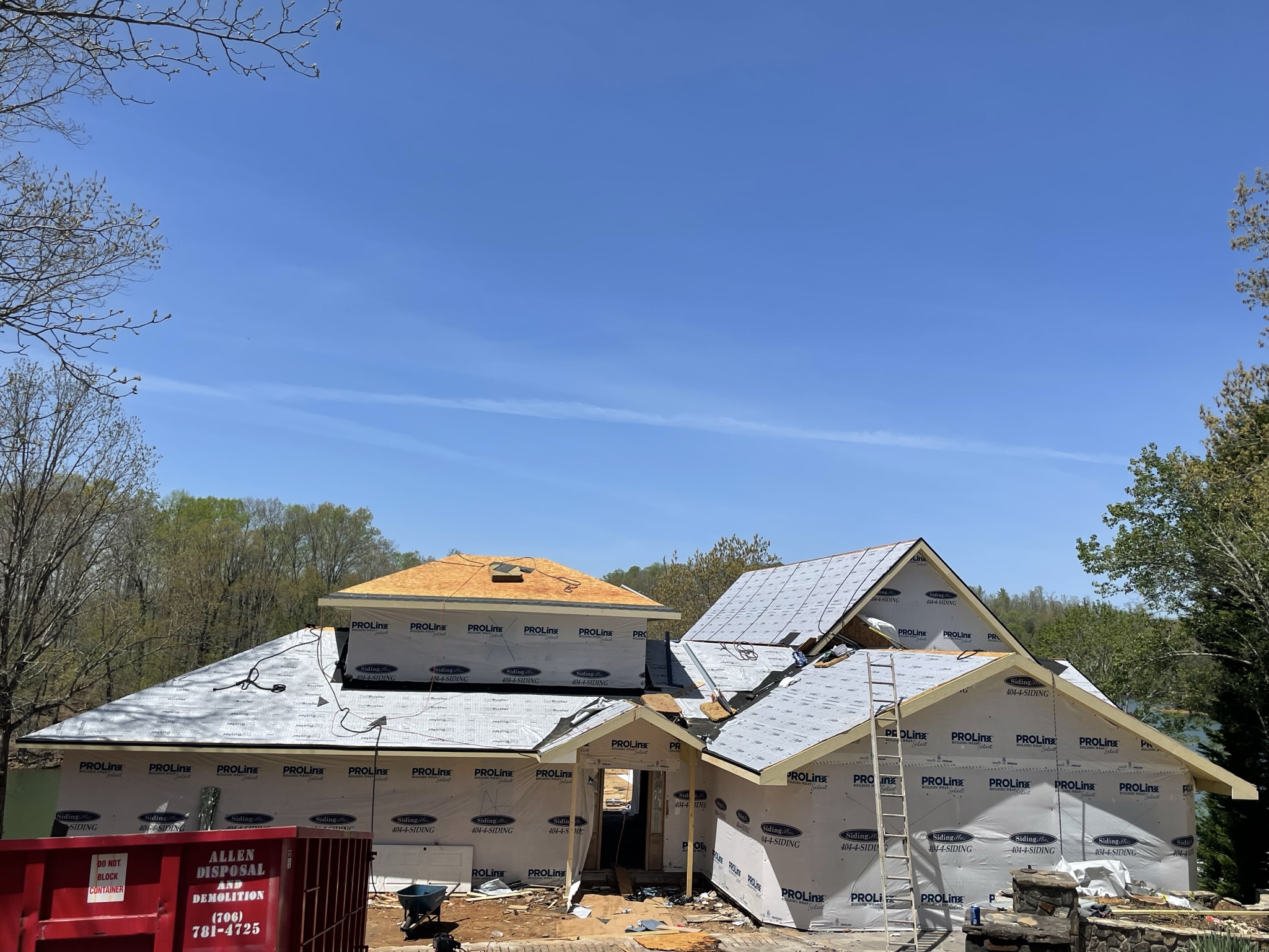 Photo of the front of the home showing the installation of the new roofing system with the removal of the ski lift